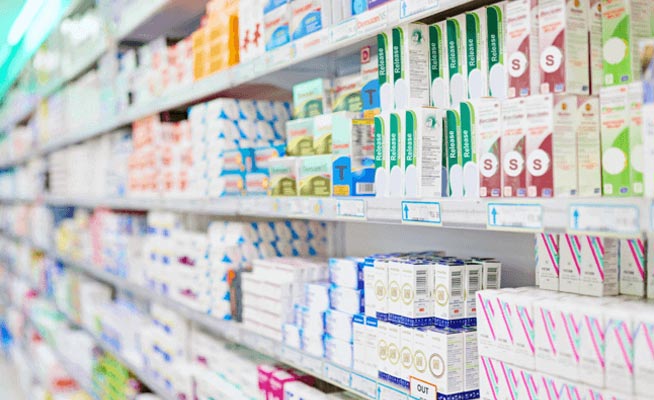 rows of prescription drugs at drug store