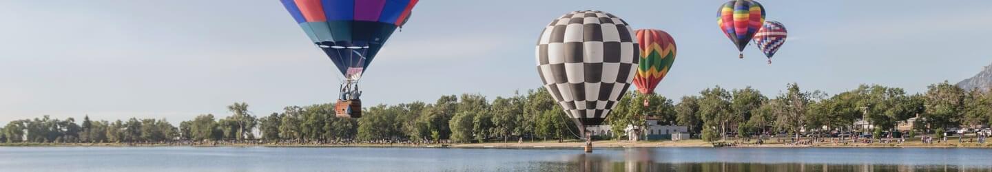 View of lake with hot air balloons