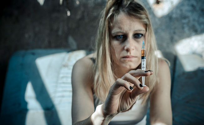 woman with heroin needle